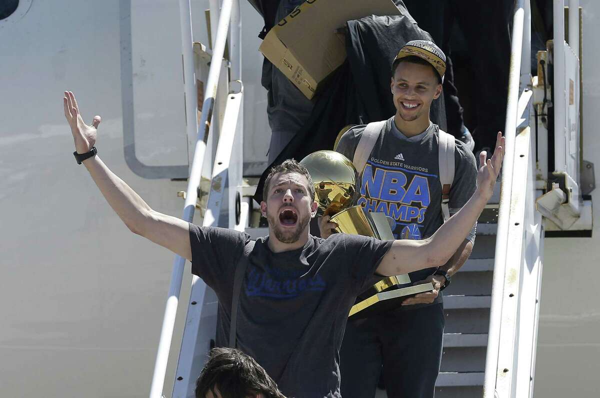 The Golden State Warriors traded David Lee, here with trophy-carrying Stephen Curry, to the Boston Celtics for Gerald Wallace.