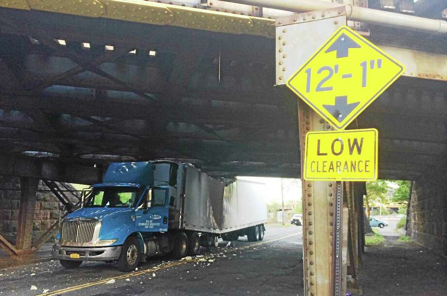 Truck carrying cooking oil, cheese crashes into rail bridge in New