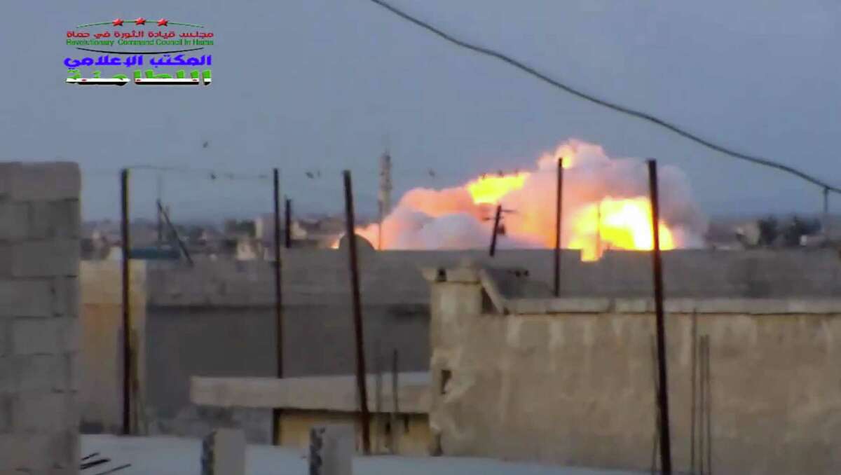 This image taken from video provided by the Syrian activist-based media group Syrian Revolutionary Command Council in Hama, which has-been verified and is consistent with other AP reporting, shows smoke rising after a Russian airstrike hit buildings in the town of Latamna in the area of Hama in Eastern Syria, Wednesday, Oct. 7, 2015.