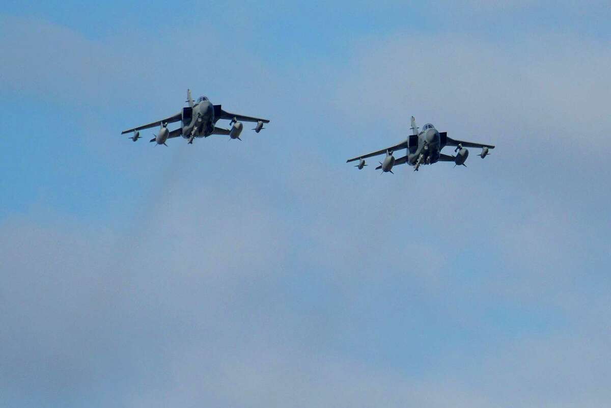 Two British Tornados warplanes fly over the RAF Akrotiri, a British air base near costal city of Limassol, Cyprus, Thursday, Dec. 3, 2015, as they arrive from an airstrike against Islamic State group targets in Syria. British warplanes carried out airstrikes in Syria early Thursday, hours after Parliament voted to authorize air attacks against Islamic State group targets there.