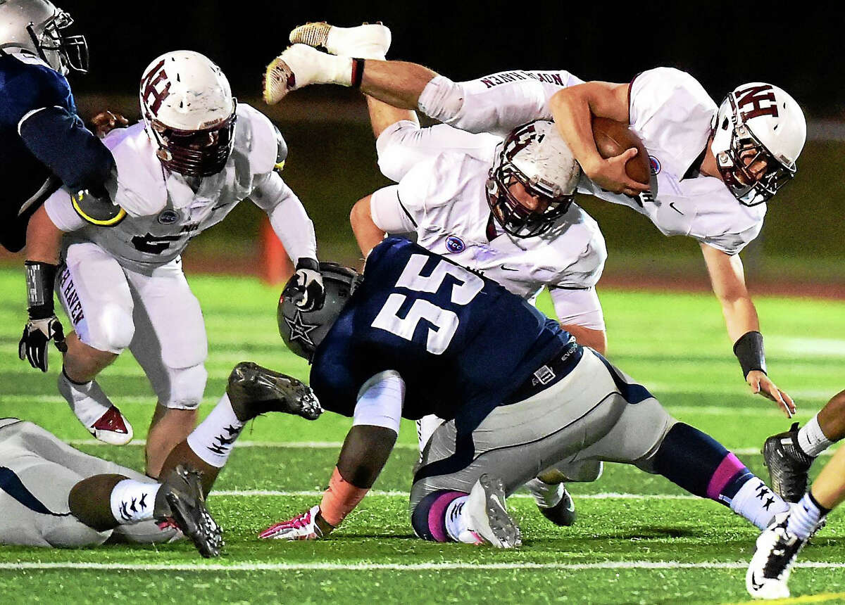 North Haven High School Running back Nicholas Ponzio dives for extra yardage against Hillhouse High School during a first quarter drive that ended in a North Haven touchdown this weekend.