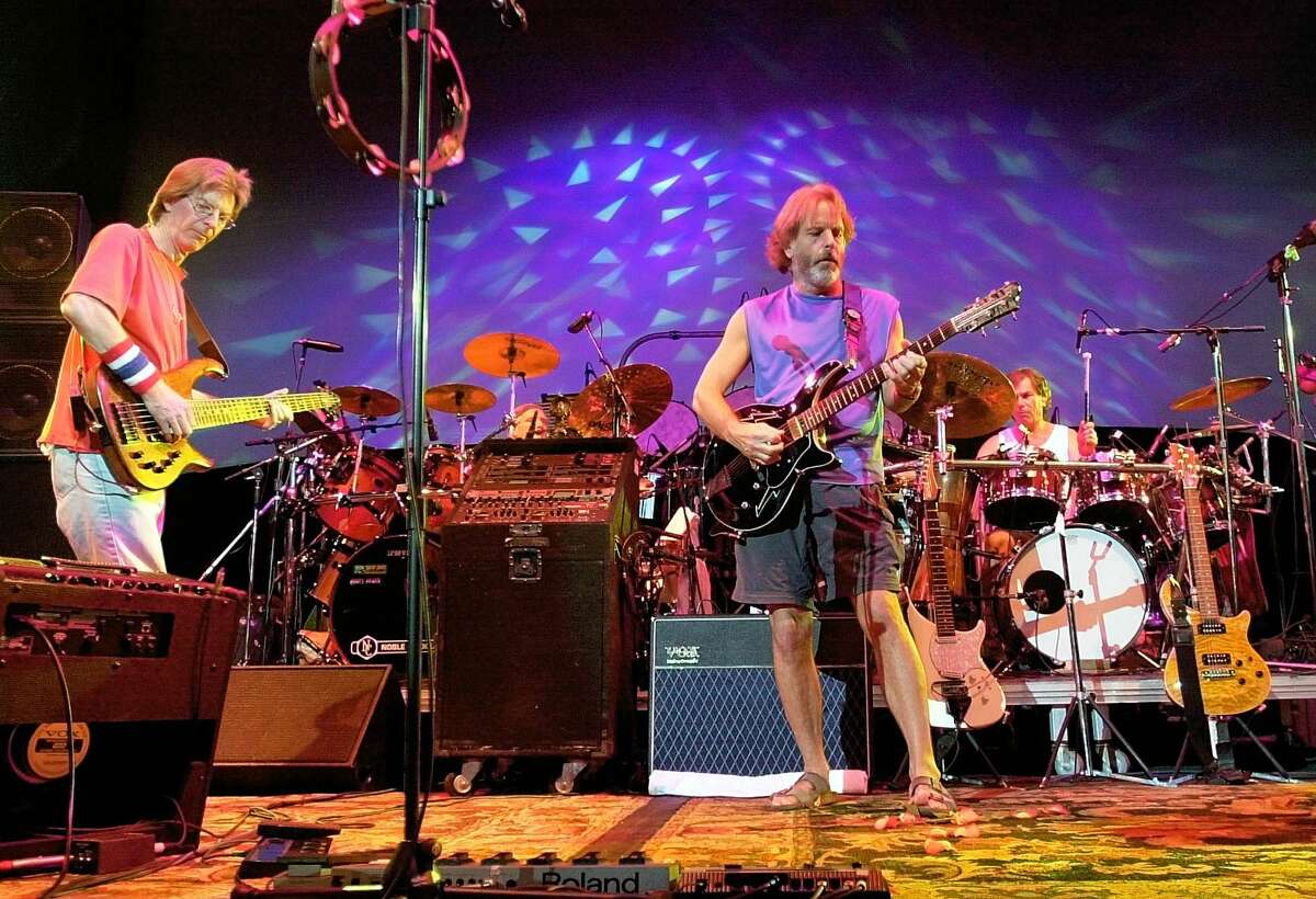 In this Aug. 3, 2002 photo, The Grateful Dead, from left, Phil Lesh, Bill Kreutzmann, Bob Weir and Mickey Hart perform during a reunion concert in East Troy, Wis. Mickey Hart, Bill Kreutzmann and Bob Weir have joined forces with John Mayer to form the band, Dead & Company. They will perform a show on Oct. 31 at Madison Square Garden in New York.
