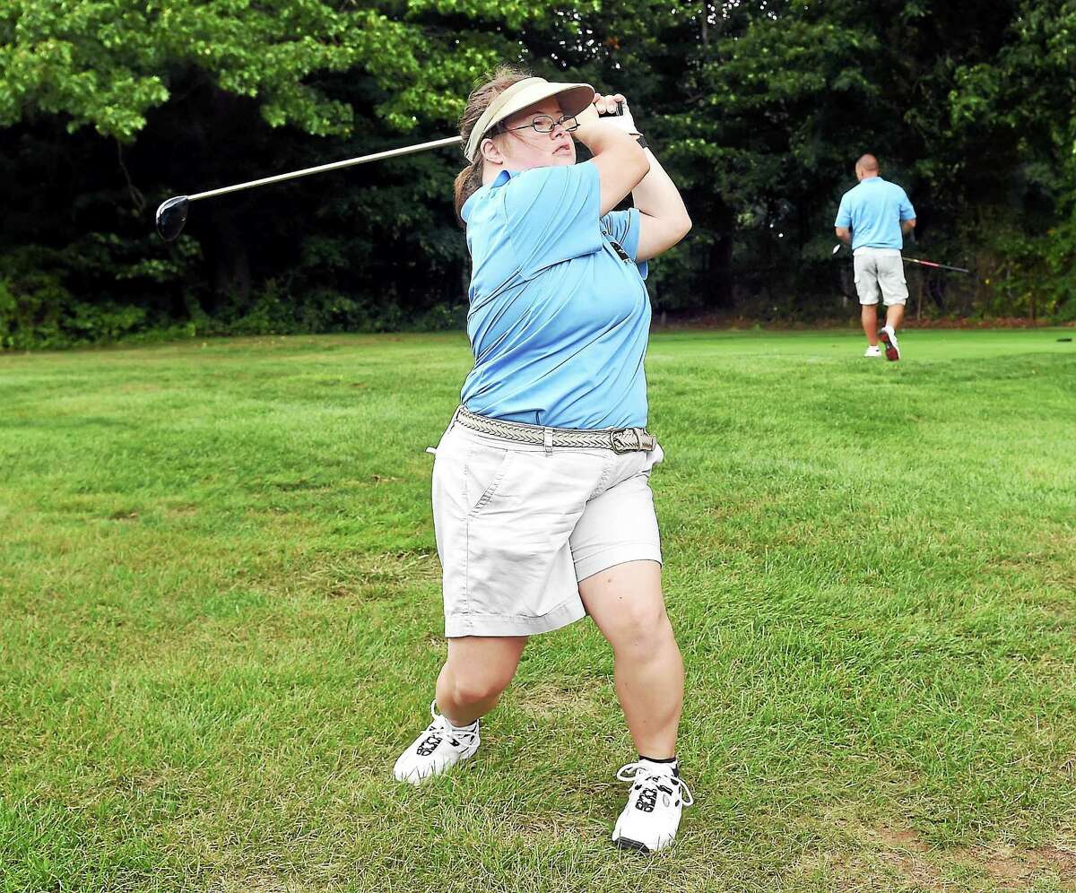 (Arnold Gold-New Haven Register) Allison Haines practices her swing at the Chapel Haven Golf Classic at the New Haven Country Club in Hamden last week.