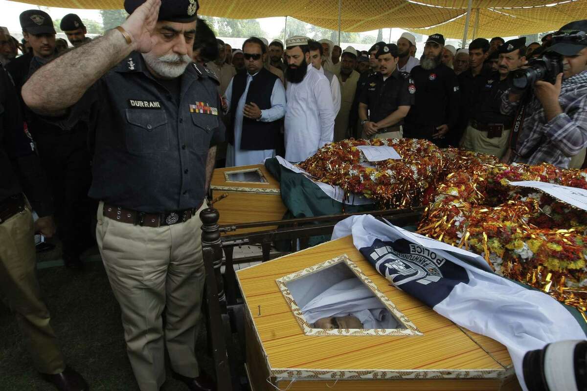 Police chief Nasir Khan Durrani salutes to police officers killed in an attack in Peshawar, Pakistan on Sept. 2, 2015. Three policemen were killed and six others injured when armed gunmen ambushed a raiding police party during a search operation in Urmar Payan area of the provincial capital, official said.