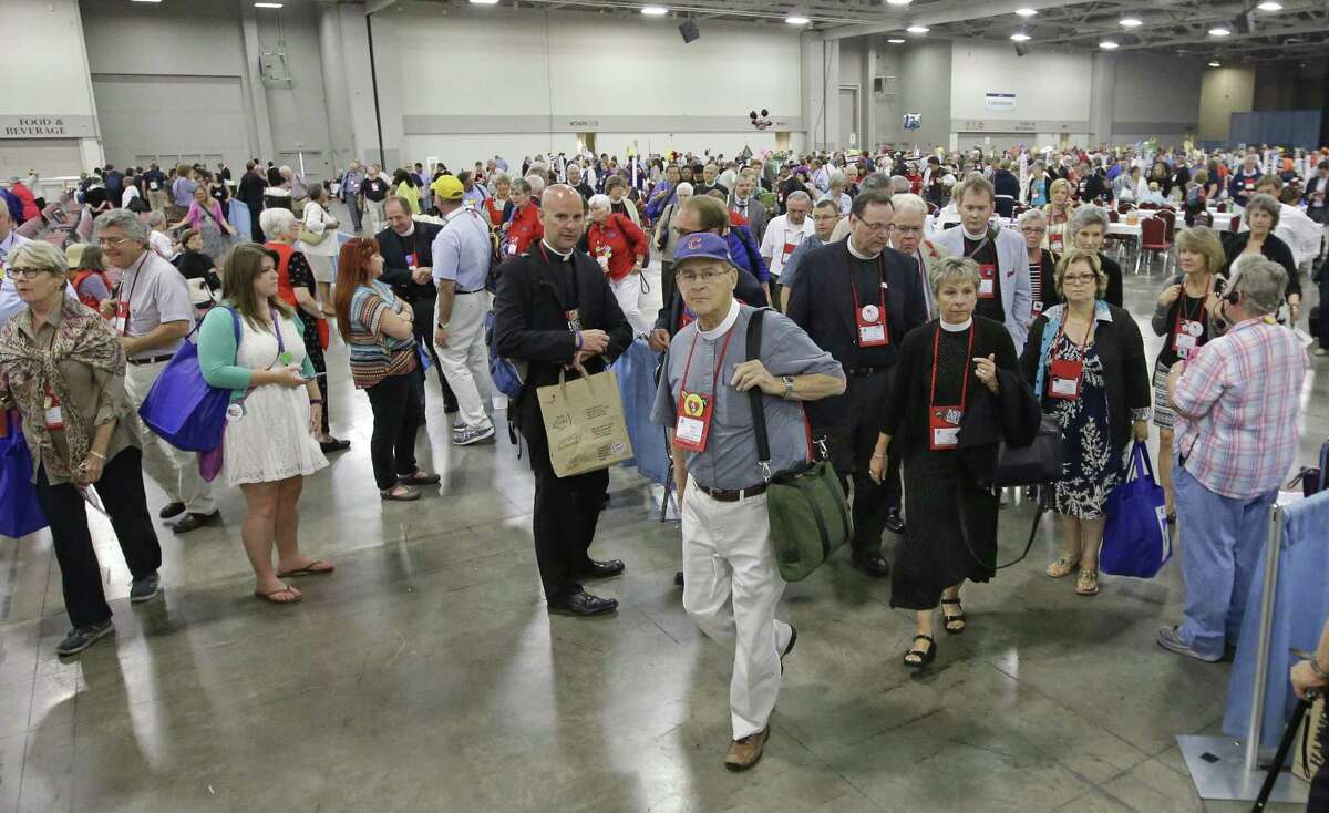 Deputies leave the hall after Episcopalians overwhelmingly voted to allow religious weddings for same-sex couples Wednesday, July 1, 2015, in Salt Lake City. The vote came in Salt Lake City at the Episcopal General Convention, just days after the U.S. Supreme Court legalized gay marriage nationwide. (AP Photo/Rick Bowmer)