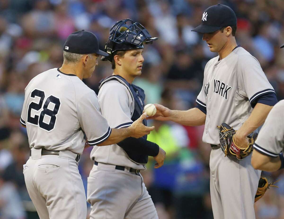 New York Yankees manager JOE GIRARDI takes the ball from BRYAN MITCHELL