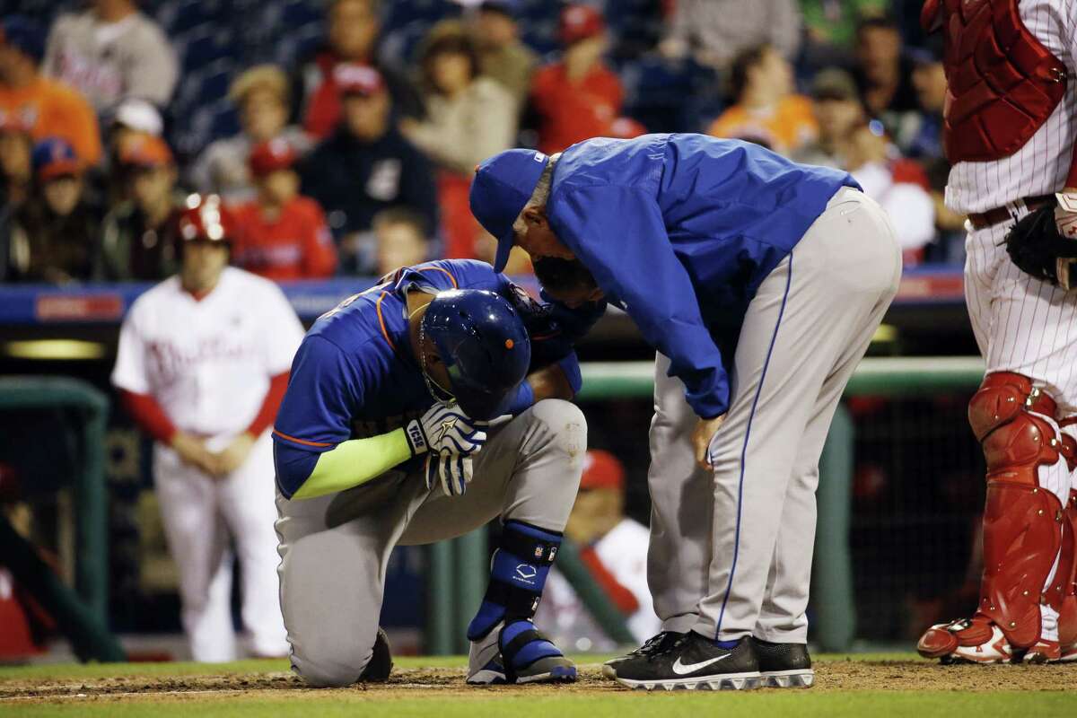 New York Mets' Yoenis Cespedes reacts after being hit by a pitch from Philadelphia Phillies' Justin De Fratus during the third inning of a baseball game, Wednesday, Sept. 30, 2015, in Philadelphia. (AP Photo/Matt Slocum)