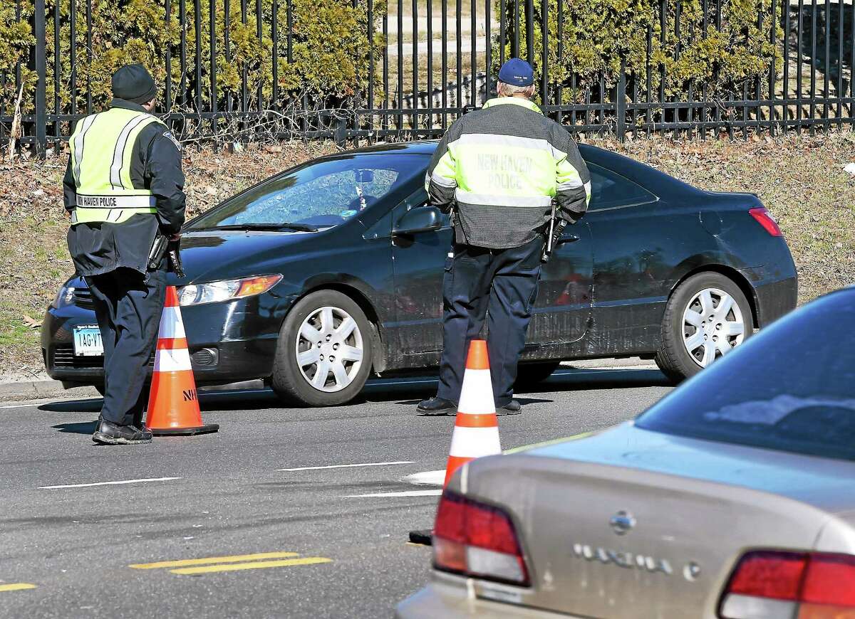 New Haven Police look for drivers using their cell phones at a check point on Rt. 80 in New Haven on 4/1/2015.