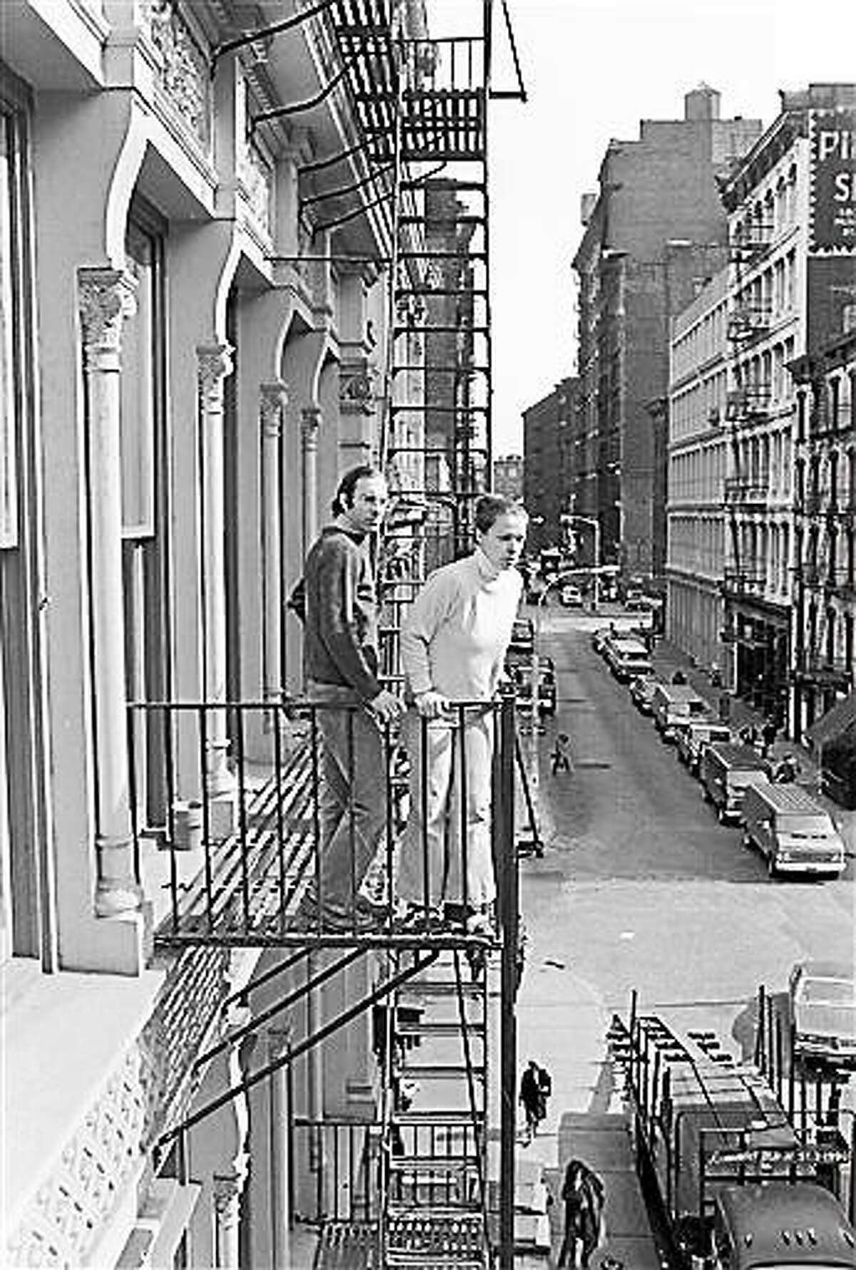 FILE - In this March 17, 1980, file photo, Stan and Julie Patz stand on the second-floor fire escape of the of their loft in the SoHo neighborhood of New York. Below them runs Prince Street, along which Etan, their 6-year-old son, set off to school on May 25, 1979, and has not been seen since. Pedro Hernandez, who worked in a nearby convenience store and is accused of killing Patz, told police 33 years after they boy's disappearance that he choked the 6-year-old and put the still-living boy into a plastic bag, boxed up the bag and left it on a street. Opening statements in Hernandez's trial are set for Friday, Jan. 30, 2015. (AP Photo/Marty Reichenthal, File)