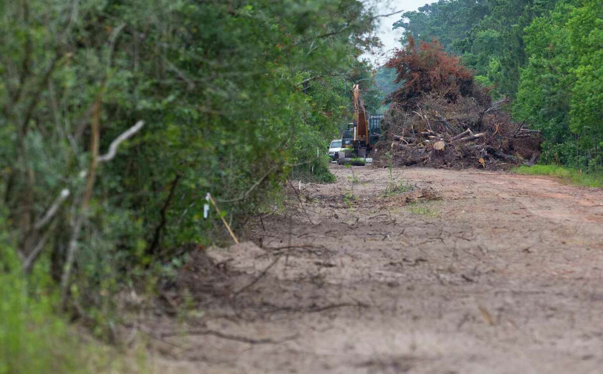 Trees and shrubs are cleared as part of a construction project to create two additional lanes on Research Forest Drive near the intersection of Branch Crossing Drive and Research Forest Drive. Thursday, May 18, 2017, in Conroe.