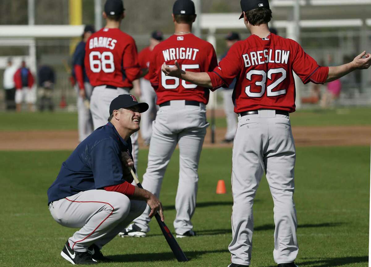 Boston Red Sox manager John Farrell, left, talks with relief pitcher Craig Breslow as the team stretches during spring training Saturday in Fort Myers Fla.