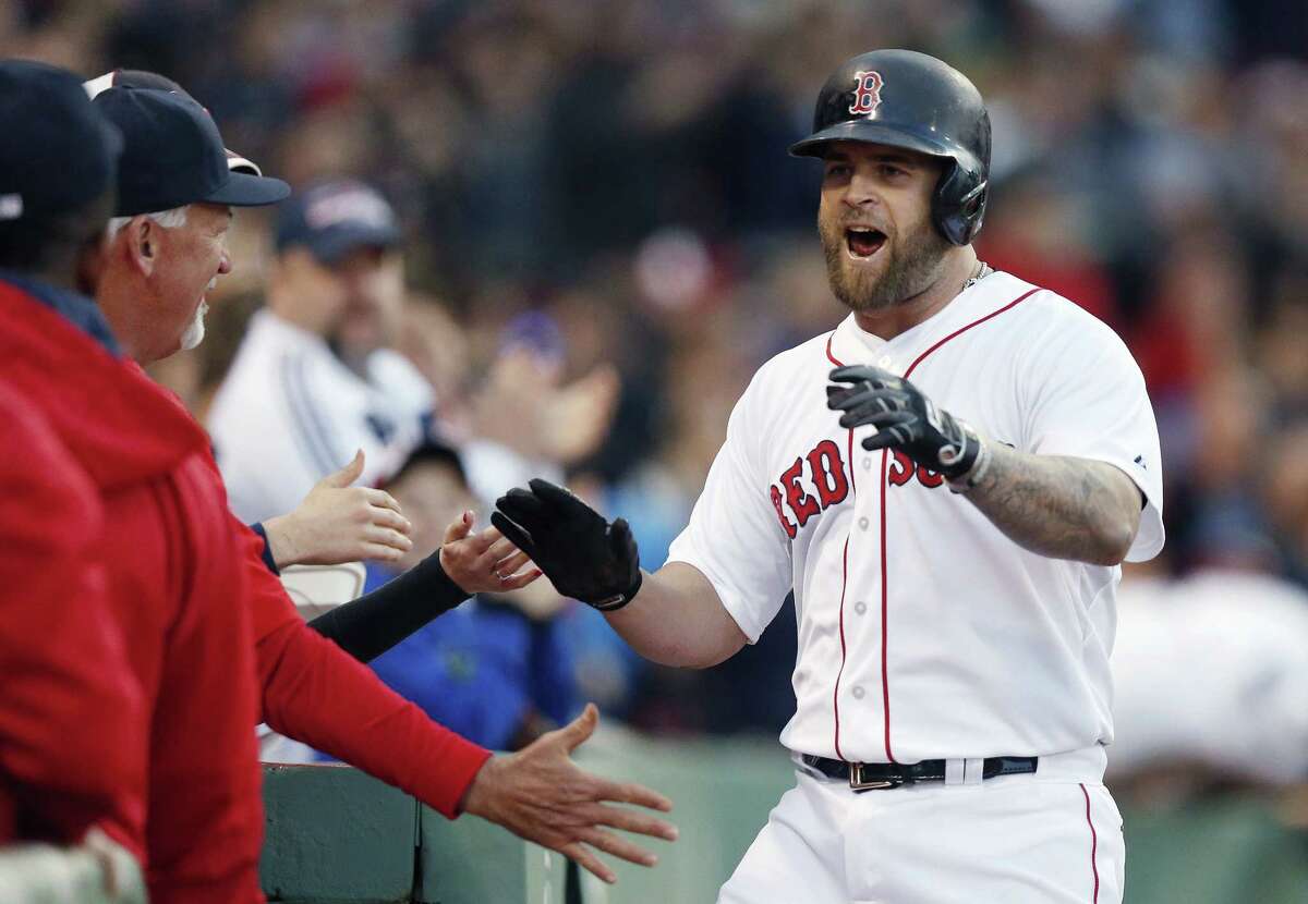 The Red Sox’s Mike Napoli, right, celebrates his solo home run during the second inning of Saturday’s game against the Los Angeles Angels. Napoli added a two-run homer in the sixth to fuel Boston’s 8-3 win.