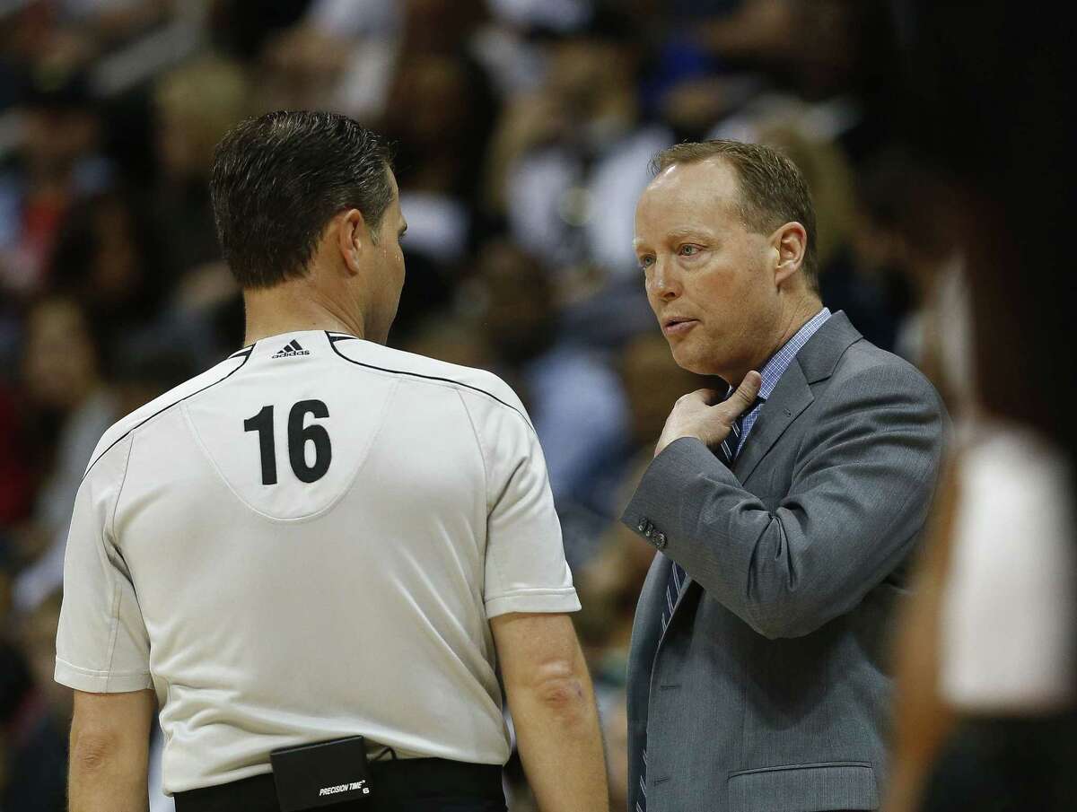 Hawks head coach Mike Budenholzer talks with referee David Guthrie during an April 13 game against the New York Knicks in Atlanta.