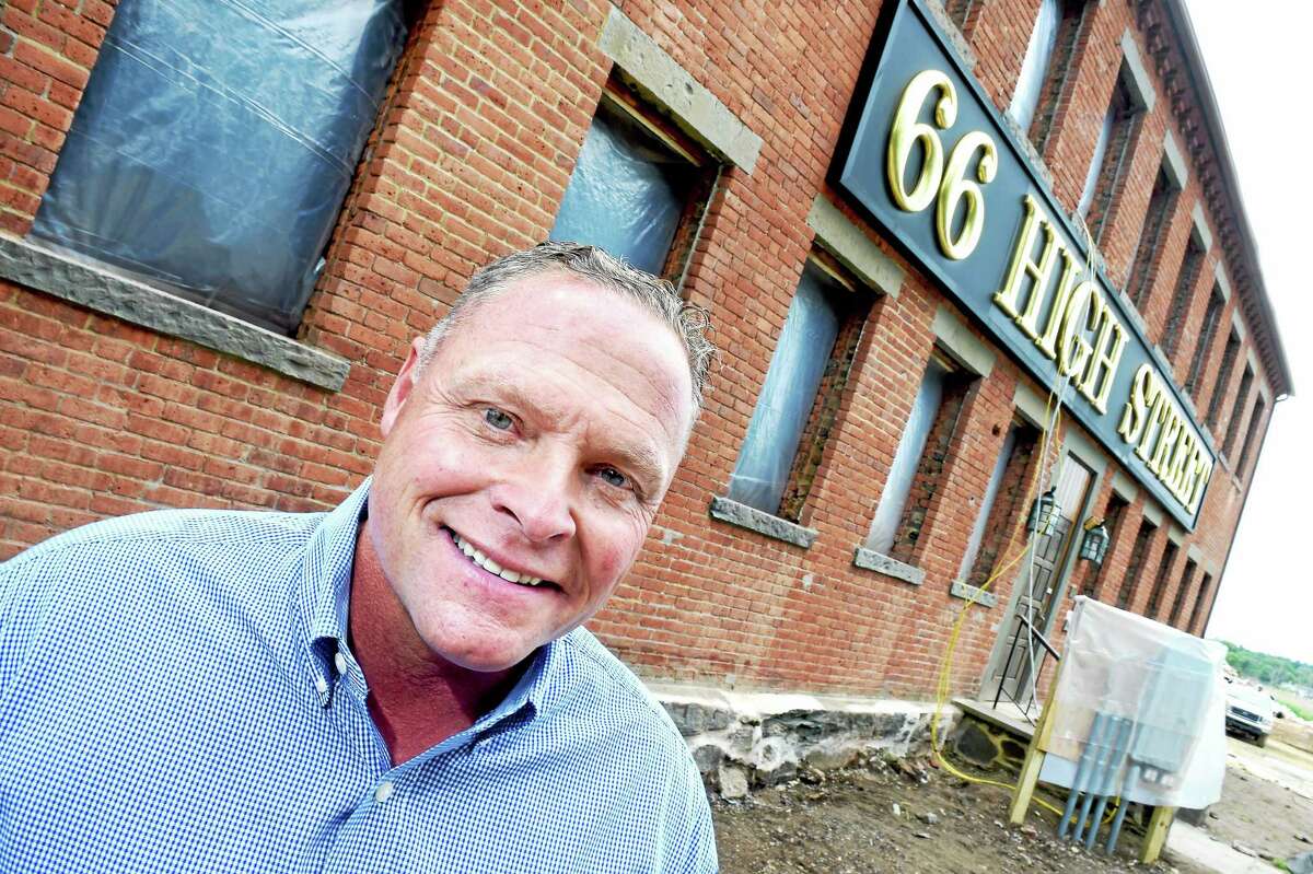 Kenny Horton, owner of Residences at 66 High Street, is photographed on 6/5/2015 in front of a factory built in 1884 being converted into luxury condominiums in Guilford.