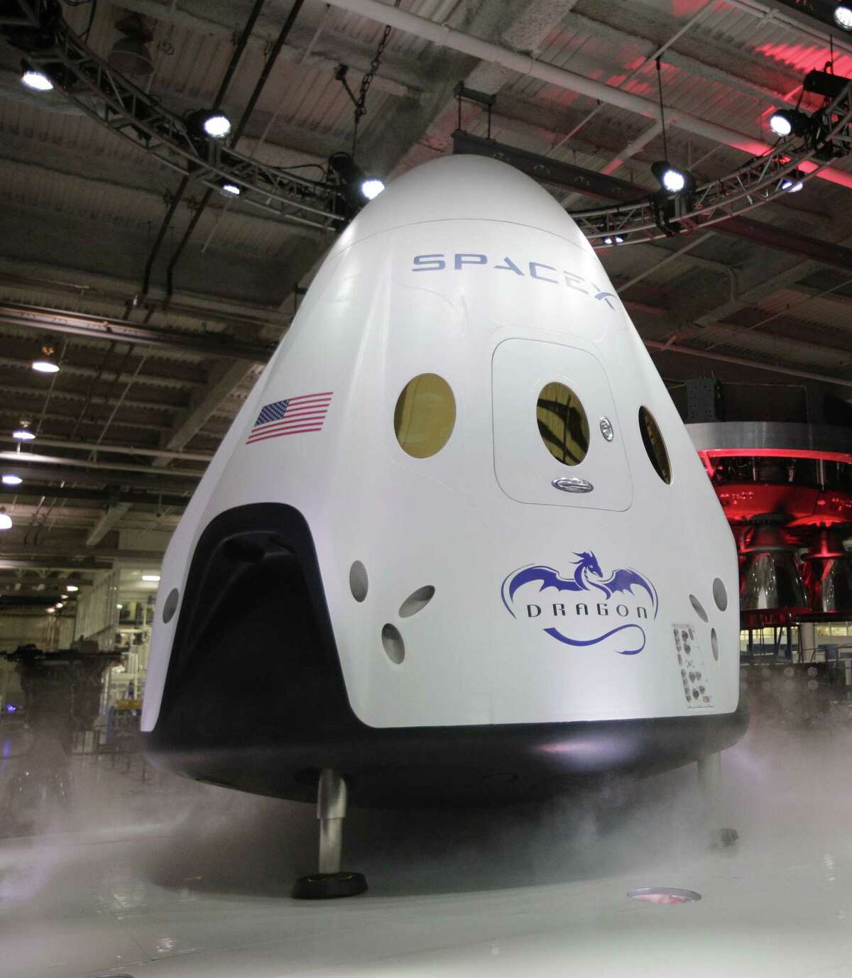 In this May 29, 2014 photo, the SpaceX Dragon V2 spaceship is unveiled at its headquarters in Hawthorne, Calif.