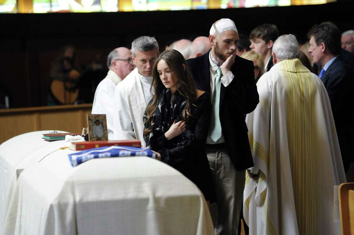 Ashley Donohoe looks at her sister’s casket during a service for Olivia Burke, 21, and Ashley Donohoe, 22, at St. Joseph Catholic Church in Cotati, Calif., on Saturday, June 20, 2015. The two woman were among the several people killed on Tuesday when a balcony snapped off the fifth floor of a Berkeley apartment building during a birthday party.