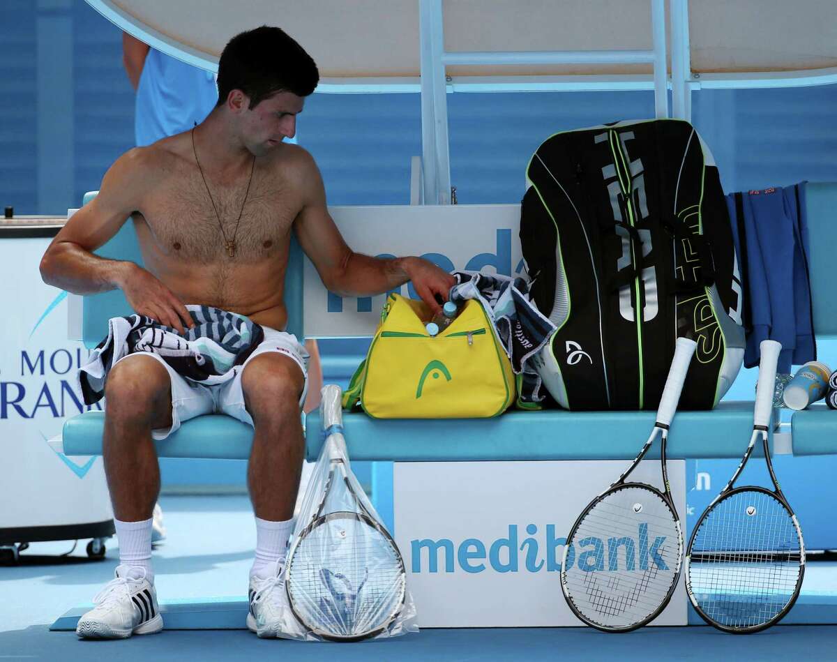 Novak Djokovic rests during a break from his win over Aljaz Bedene in the first round of the Australian Open on Tuesday in Melbourne, Australia.