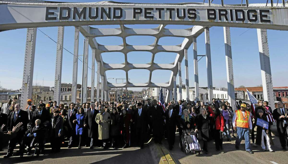 A group crosses the Edmund Pettus Bridge in Selma, Ala.
