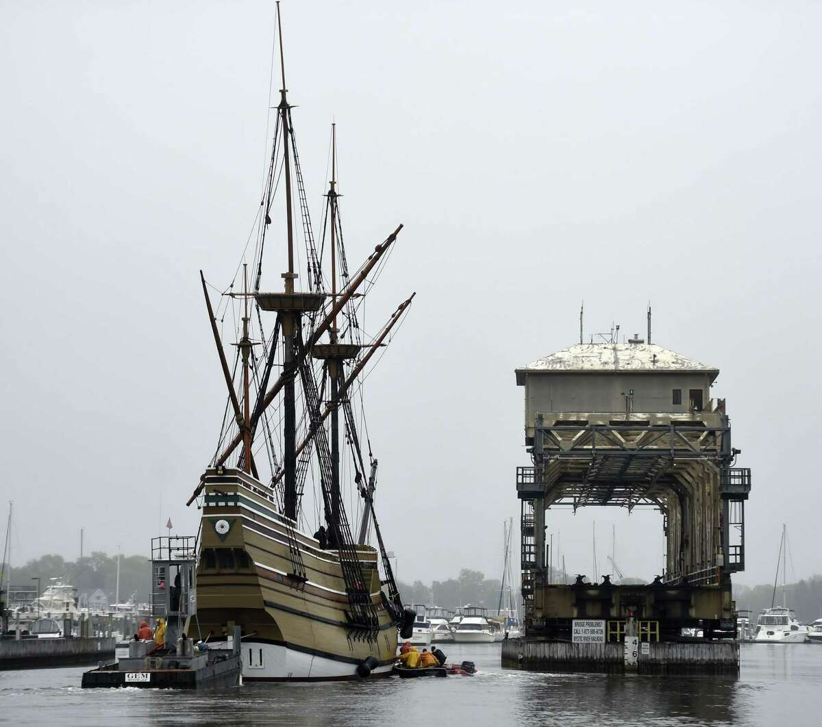 Towed by the tug Jaguar with support from Gwenmore Marine and Mystic Seaport waterfront small craft, the Mayflower II, a 1957 replica of the ship that carried the Pilgrims to Massachusetts in 1620, passes the Mystic River railroad bridge during the transit of the Mystic River, Tuesday, May 19, 2015 in Mystic, Conn. The ship, which is being restored at the Mystic Seaport's Henry B. duPont Preservation Shipyard in a cooperative effort between the Seaport and Plimoth Plantation, is en route back to Plymouth, Mass., for the summer tourism season and will return in the fall for another winter of work. (Sean D. Elliot/The Day via AP) MANDATORY CREDIT