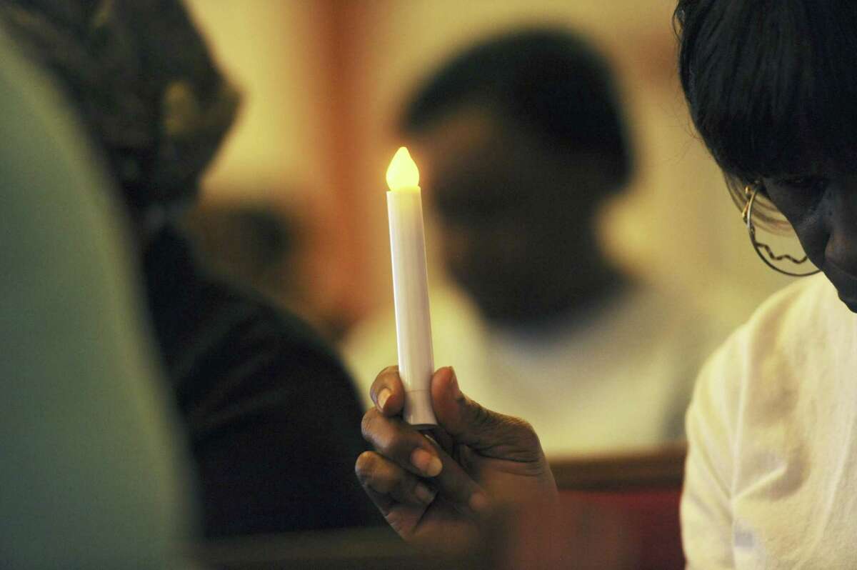 Parishioners gather during a vigil to mourn the lives lost at the shooting in Charleston, S.C., Thursday, June 18, 2015, at the Union Memorial A.M.E. Church in Benton Harbor, Mich. Dylann Storm Roof, 21, was arrested Thursday in the slayings of several people, including the pastor at a prayer meeting inside a historic black church. (Don Campbell/The Herald-Palladium via AP)