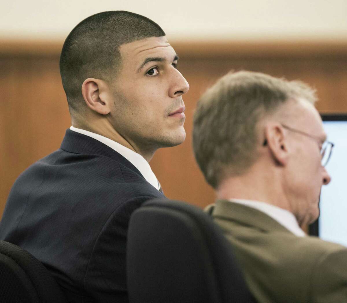 Aaron Hernandez sits with his attorney Charles Rankin during the former New England Patriots tight end’s murder trial on Friday in Fall River, Mass.