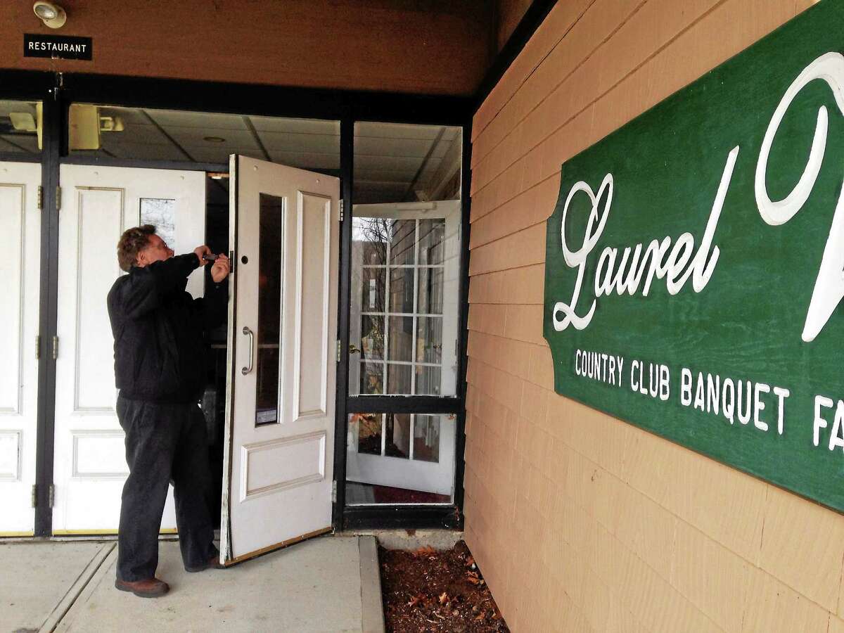 Ed Klatzkin of Charm’s Security changing the locks at Laurel View Country Club’s banquet facility Wednesday morning.