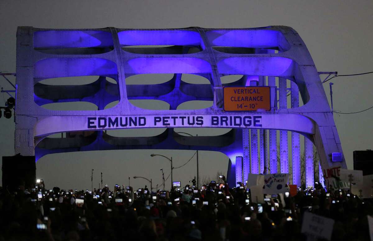 In this Jan. 18, 2015 file photo, marchers hold up a their cellular phones to record the rapper Common and singer songwriter John Legend perform at the foot of the Edmund Pettus Bridge in honor of Martin Luther King Jr., in Selma, Ala.