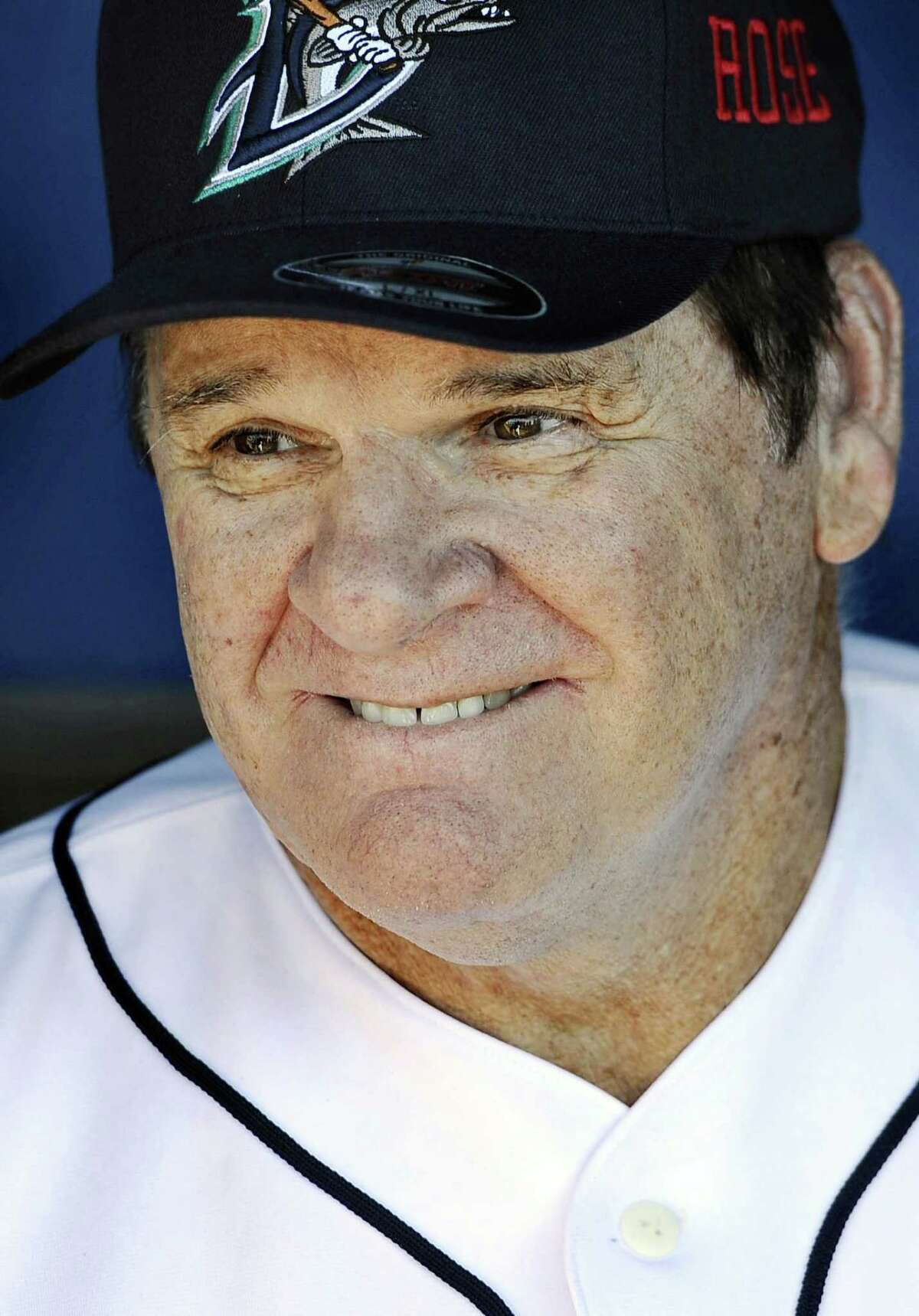 In this June 16, 2014 file photo, Pete Rose smiles while sitting in the dugout at The Ballpark at Harbor Yard in Bridgeport.