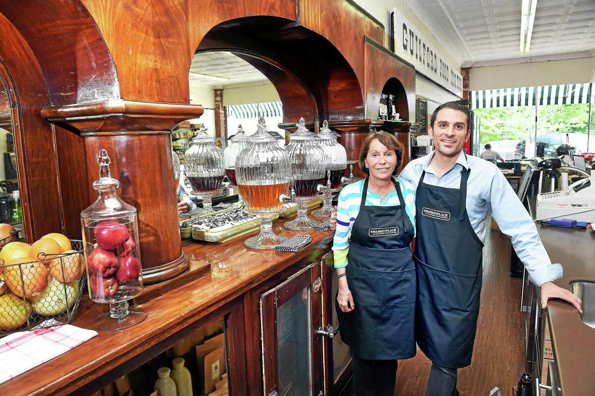 Co-owners Dee Jacob (left) and Jason Iglesias of The Marketplace at Guilford Food Center at 77 Whitfield St. in Guilford are photographed at the 1930’s art deco bar which now serves as the beverage bar on 5/18/2015.