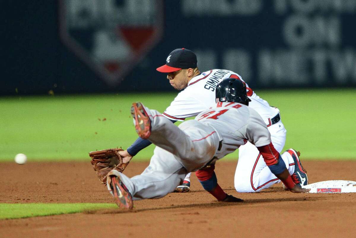 Red Sox left fielder Alejandro De Aza (31) steals second base as Atlanta Braves shortstop Andrelton Simmons reaches for the ball.