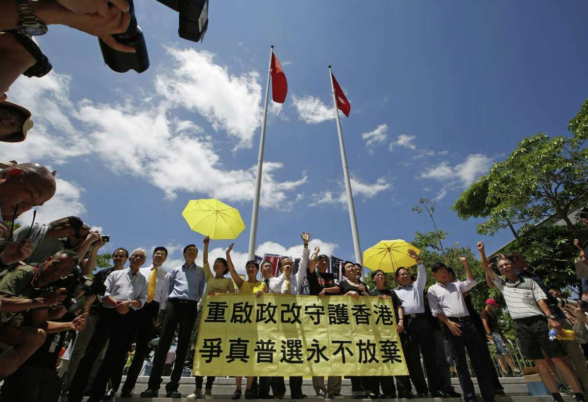 Pro-democracy lawmakers celebrate outside the Legislative Council in Hong Kong, Thursday, June 18, 2015. The Hong Kong government's controversial Beijing-backed election reforms were defeated Thursday by pro-democracy lawmakers. (AP Photo/Kin Cheung)