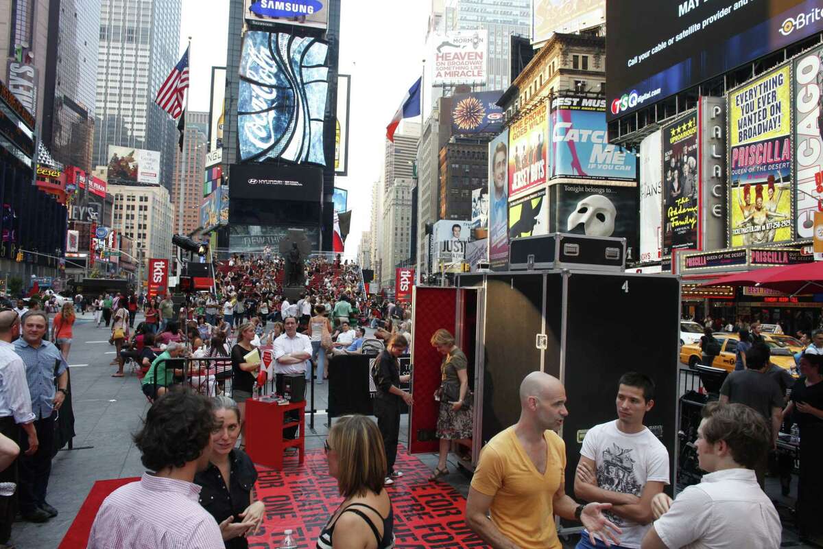 FILE - In this June 7, 2011 file photo, an audience member steps out of the "Theatre for One" performance space in New York's Times Square. Theatre for One, a 4-foot-by-8 foot portable theater, allows one audience member at a time to see one short play performed by a single actor. The theater will be parked in three Manhattan locations for the next two months, offering shows for free. Which show the audience sees is largely the luck of the draw, adding to this unique theatrical event. (AP Photo/Jason DeCrow, File)