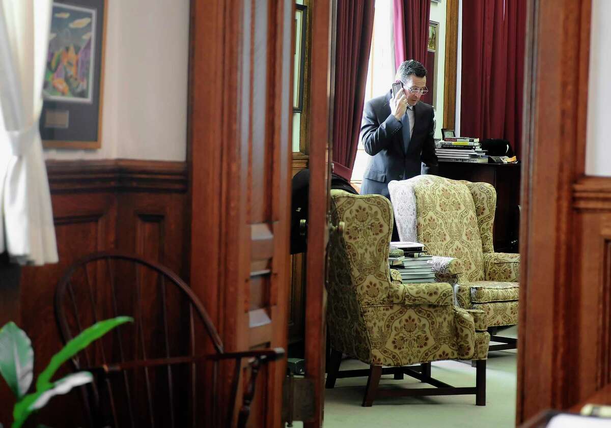 Connecticut Gov. Dannel P. Malloy takes a phone call in his office at the state Capital before he is sworn in for his second term on Jan. 7, 2015 in Hartford, Conn.