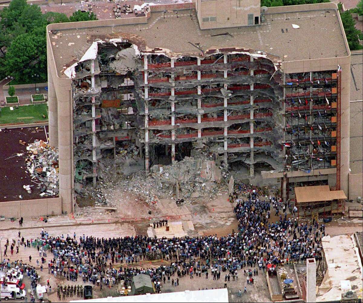 FILE - In this May 5, 1995 file photo, a large group of search and rescue crew attends a memorial service in front of the Alfred P. Murrah Federal Building in Oklahoma City. The blast killed 168 people _ including 19 children _ injured hundreds more and caused hundreds of millions of dollars in damage to structures and vehicles in the downtown area.