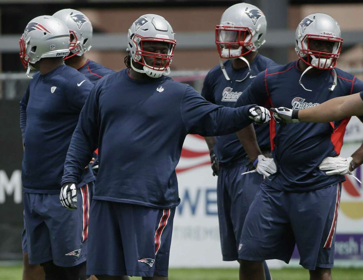 New England Patriots first-round draft pick Malcom Brown fists bumps a teammate during minicamp Wednesday in Foxborough, Mass.
