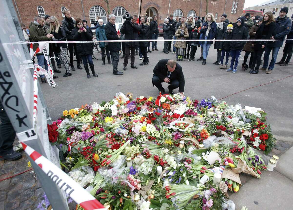 Flowers are placed in front of the cultural club where one person was killed in Copenhagen, Denmark, on Feb. 15, 2015. The alleged shooter was later killed by police who believe he also shot another person at a synagogue.