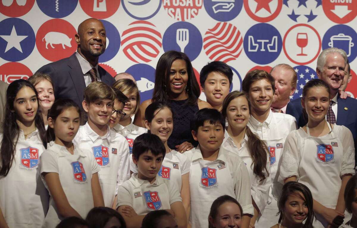 U.S. first lady Michelle Obama poses after a cooking demonstration at the James Beard American Restaurant with Italian and American middle school students in Milan, Italy, Wednesday, June 17, 2015. Michelle Obama is in Milan on the second leg of a European trip that puts an international spin on her core initiatives. (AP Photo/Antonio Calanni)