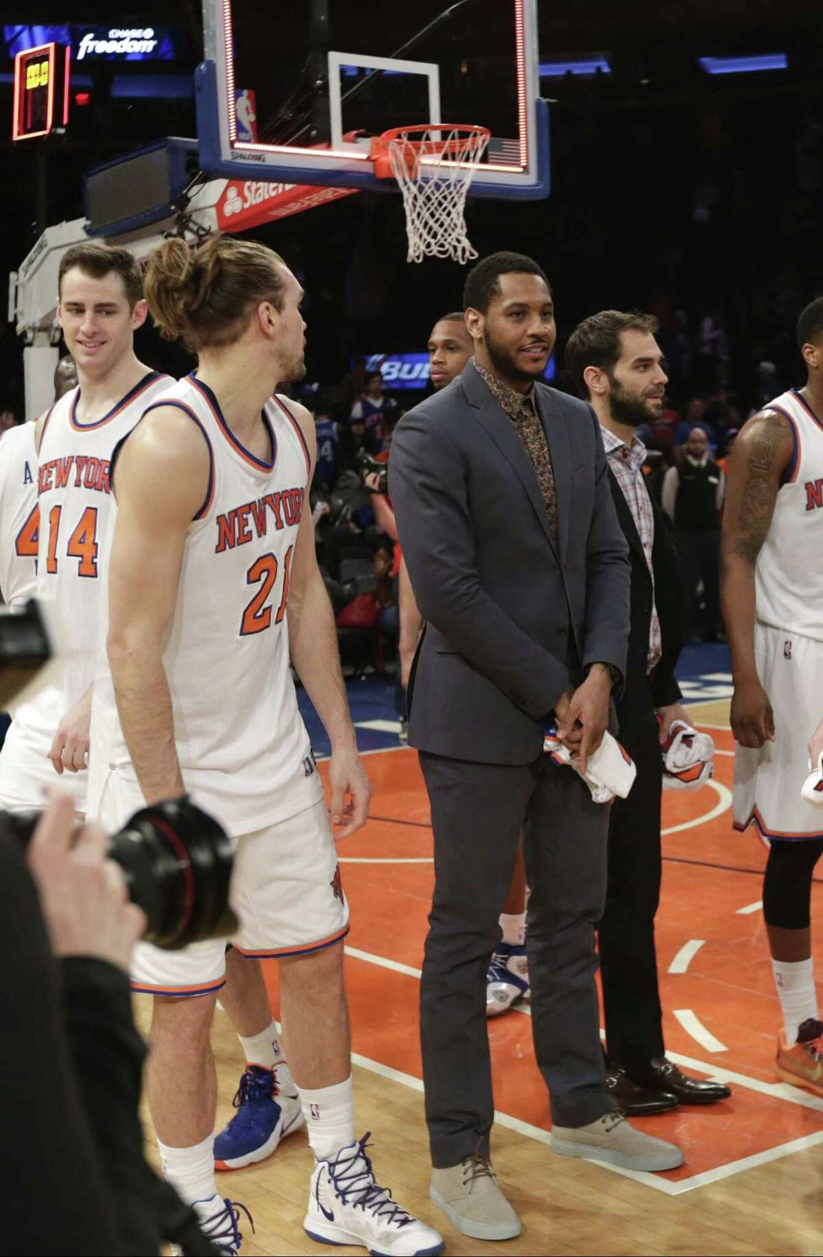 Knicks star Carmelo Anthony stands on the court with his teammates after a game against the Detroit Pistons on Wednesday in New York.