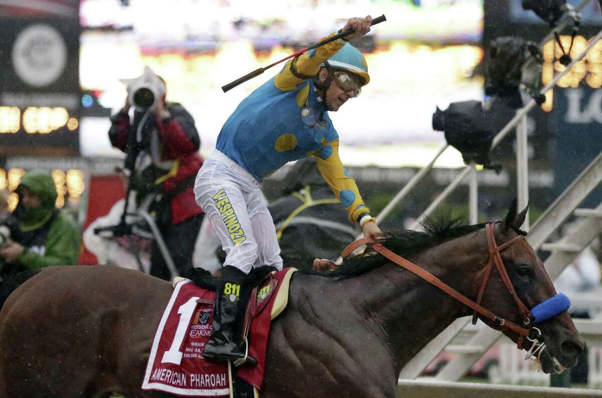Jockey Victor Espinoza, celebrates aboard American Pharoah after winning the 140th Preakness Stakes horse race at Pimlico Race Course, Saturday, May 16, 2015, in Baltimore.