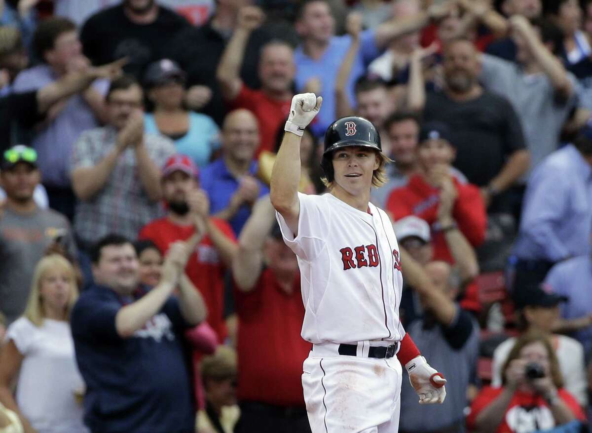 Boston’s Brock Holt gestures after hitting a triple in the eighth inning. Holt hit for the cycle in the contest.
