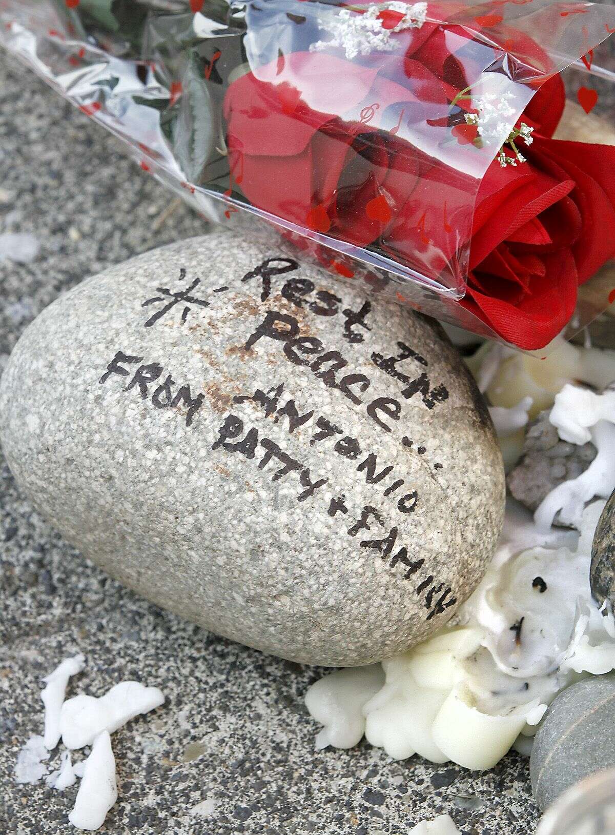 Melted candle wax, a rock and roses are part of an impromptu memorial for Antonio Zambrano-Montes set up on the sidewalk Thursday Feb. 12, 2015 outside of Vinny's Bakery & Cafe in Pasco Wash. It's at the site where the Pasco man was shot and killed by police officers on February 10, 2015. Four people have been shot and killed by police in recent months in this agricultural city of 68,000 in southeastern Washington, and the most recent death of an orchard worker accused of throwing rocks at officers has sparked protests after witnesses said he was running away. (AP Photo/The Tri-City, Herald, Bob Brawdy)