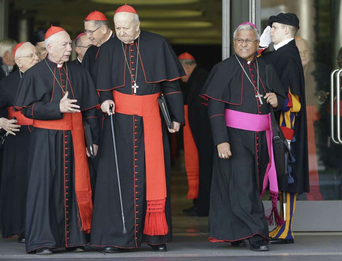 Soane Patita Paini Mafi, Archbishop of Tonga, right, leaves at the end of a special consistory with cardinals and bishops, in the Synod hall at the Vatican, Thursday, Feb. 12, 2015. Pope Francis met with cardinals and bishops who will take part in the upcoming Feb. 14, 2015 consistory during which he will elevate 20 new cardinals. (AP Photo/Andrew Medichini)