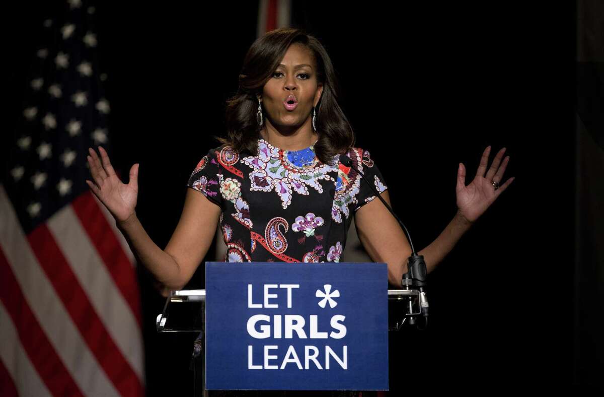 U.S. first lady Michelle Obama addresses students in the main hall of Mulberry School for Girls before taking part in a question and answer session in east London, Tuesday, June 16, 2015. Schoolgirls in east London greeted U.S. first lady Michelle Obama with song, interpretive dance and squeals of joy Tuesday as she traveled to the British capital to promote education for girls. (AP Photo/Matt Dunham)