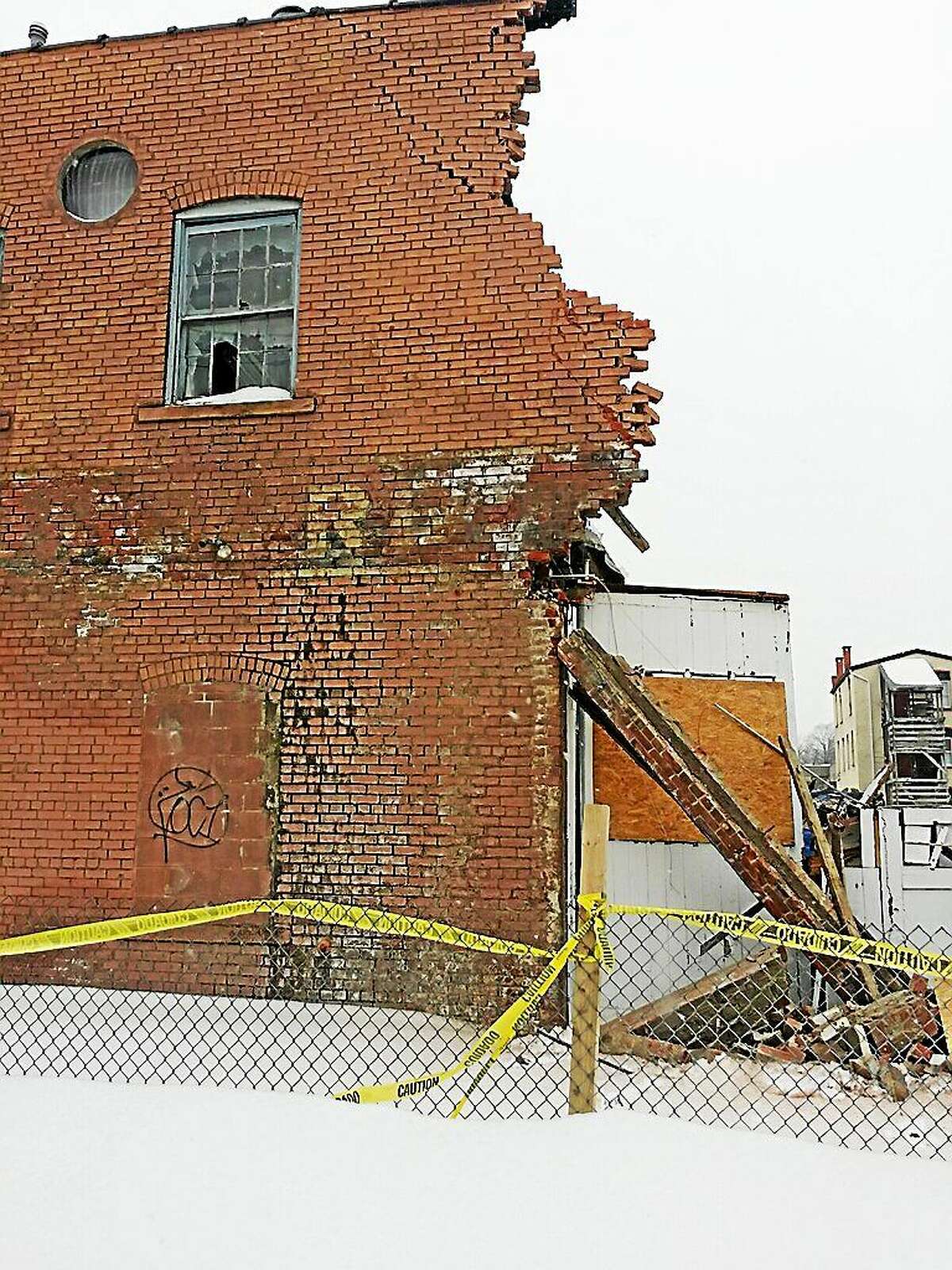 Blighted commercial buildings at 67-69 Minerva St. in Derby are demolished Thursday.