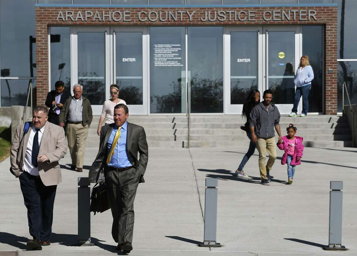 People enter and leave the Arapahoe County District Court in Centennial, Colo., Monday April 13, 2015. The jury selection process in the trial of Aurora theater shooting suspect James Holmes entered its final stage Monday when attorneys began questioning prospective jurors as a large group. Holmes is charged with killing 12 people and wounding more than 50 in a crowded Aurora, Colorado movie theater in 2013. (AP Photo/Brennan Linsley)