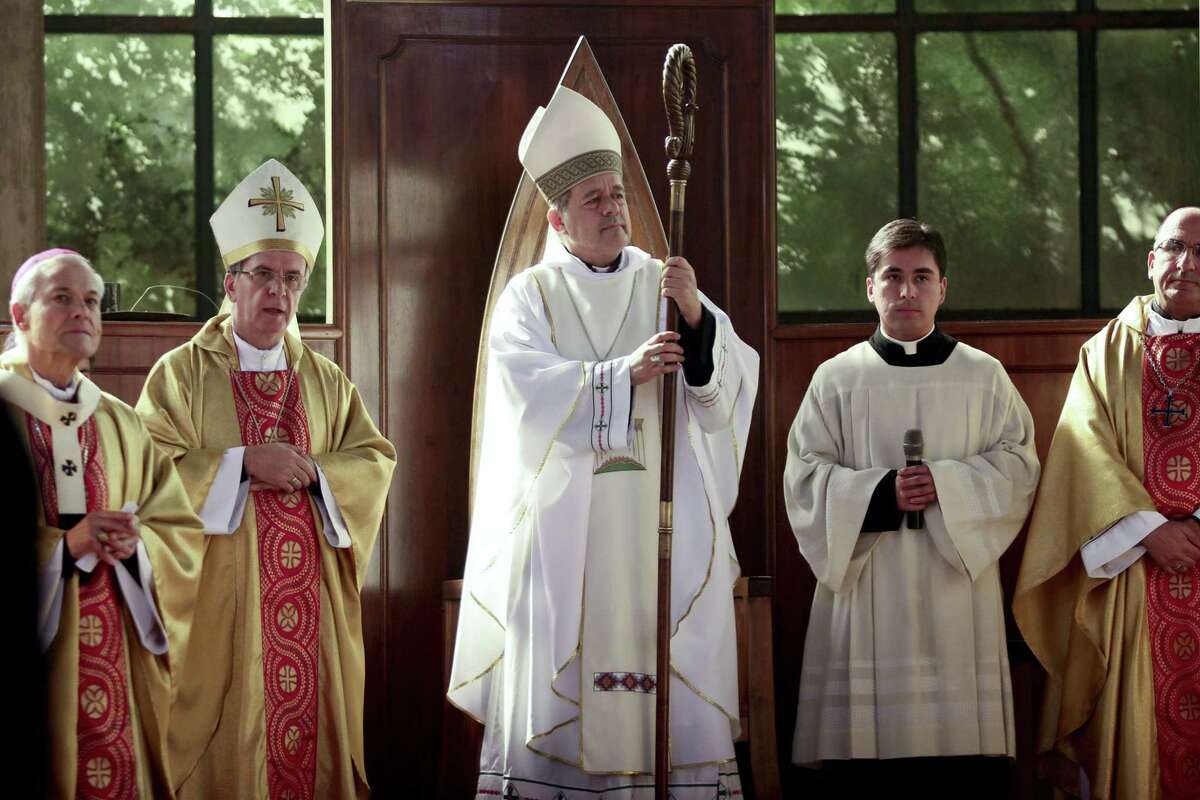 FILE -- In this March 21, 2015 file photo, Rev. Juan Barros, center, stands as he attends his ordination ceremony as bishop in Osorno, southern Chile. Four members of Pope Francis' sex abuse advisory commission headed to Rome on Sunday, April 12, 2015 to voice their concerns in person about Francis' appointment of a Chilean bishop accused of covering up for the country's most notorious molester. (AP Photo/Mario Mendoza Cabrera, File) CHILE OUT - NO USAR EN CHILE