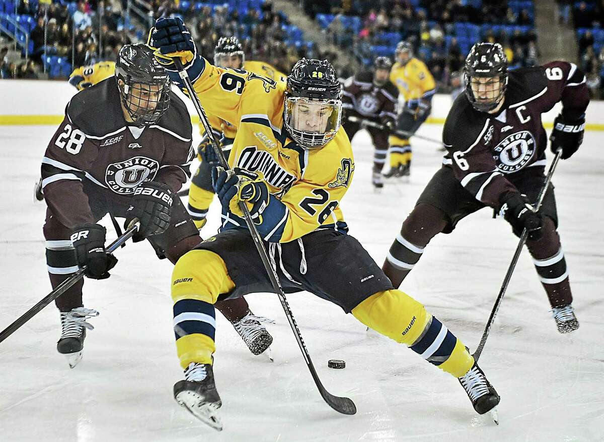 Quinnipiac’s Travis St. Denis battles Union’s Noah Henry (28) and David Roy (26) during the Dutchmen’s 3-2 win on Saturday night in the second game of a best-of-3 ECAC Hockey quarterfinal series at High Point Solutions Arena in Hamden.