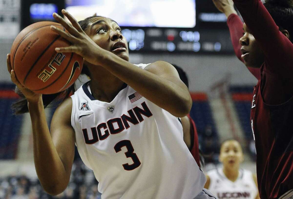 UConn’s Morgan Tuck, left, looks to shoot as Temple’s Safiya Martin defends during the first half of Wednesday’s game. UConn won 92-58.