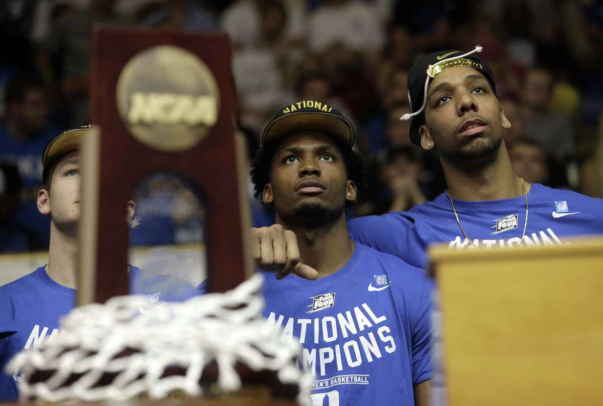Duke’s Grayson Allen, left, Justise Winslow, center, and Jahlil Okafor watch a video during a homecoming celebration for the national champions at Cameron Indoor Stadium on April 7 in Durham, N.C.