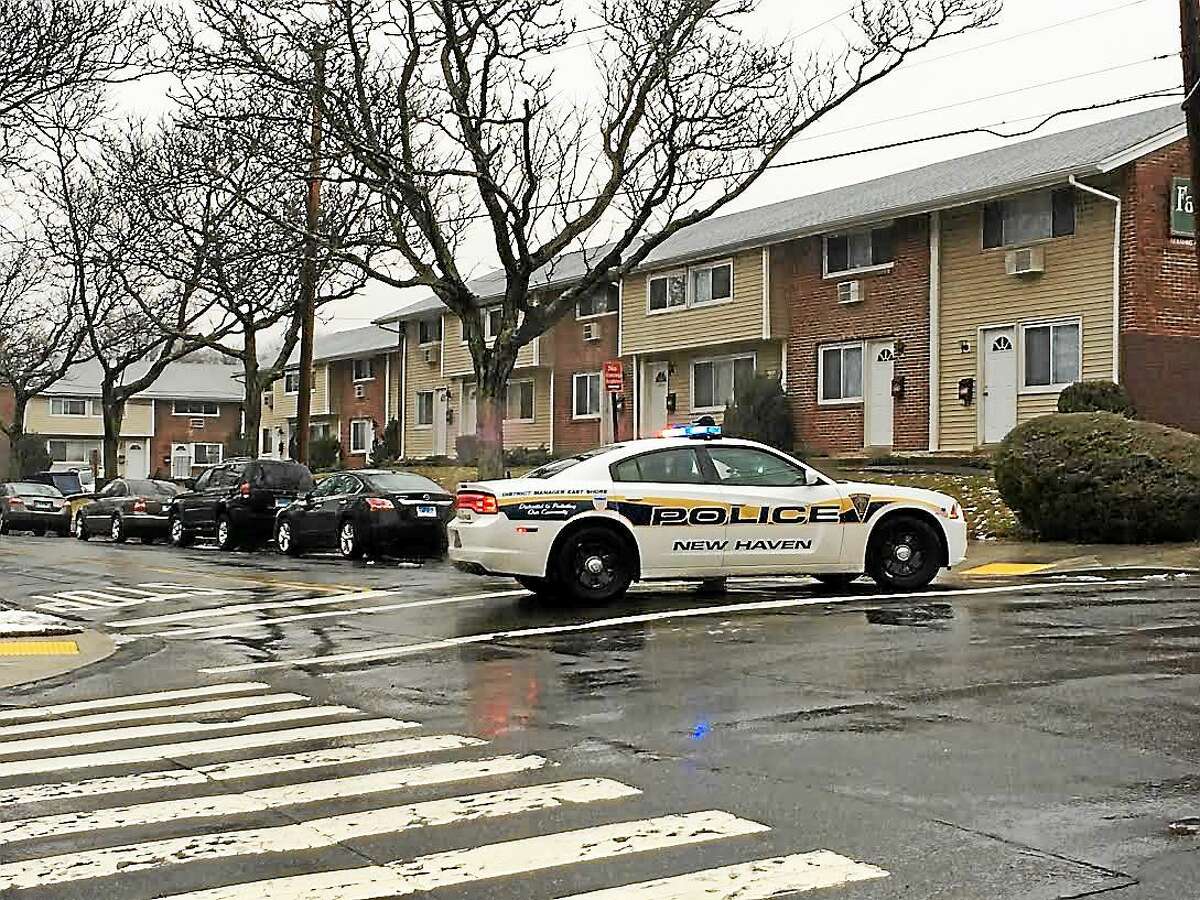 Police investigate shots fired on Russell Street in New Haven on Monday.